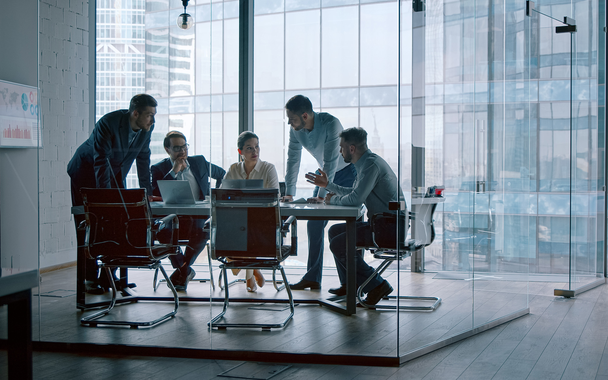 Group Of Business People Working With Technology At A Meeting In A Conference Room