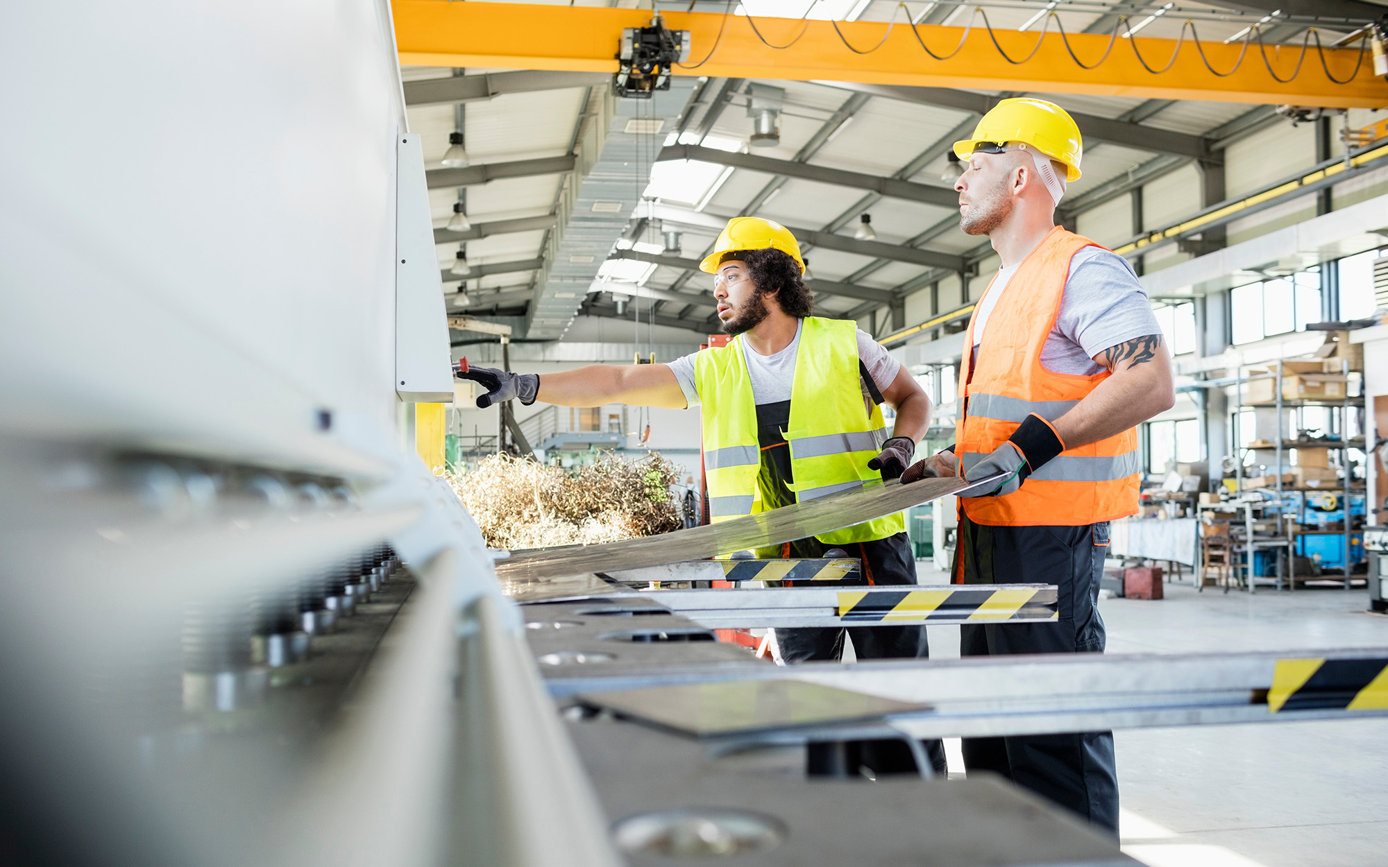 Male Manual Workers Manufacturing Sheet Metal At Industry