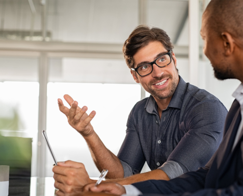 Side View Of Two Happy Business People Conducting One On One Meeting