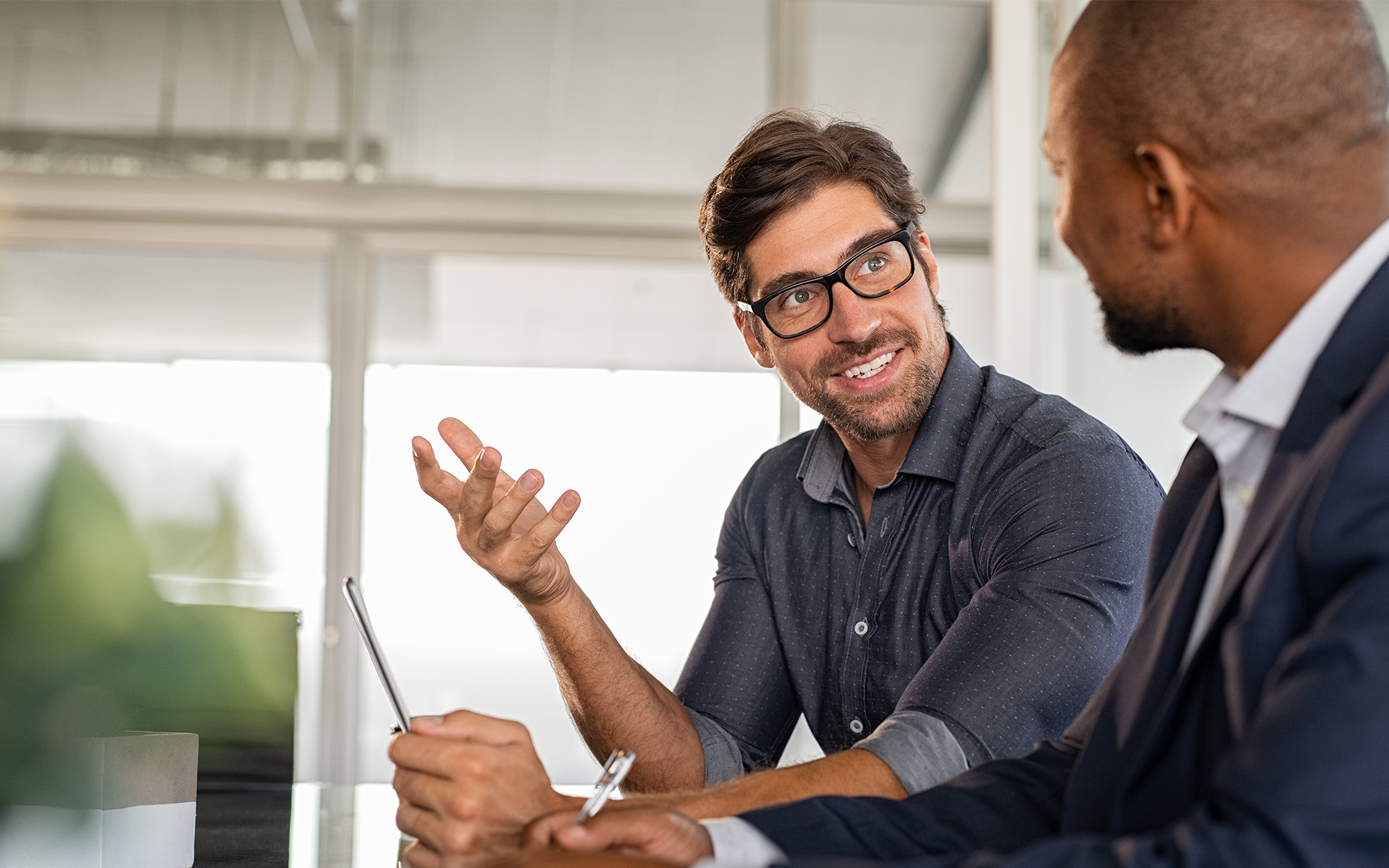 Side View Of Two Happy Business People Conducting One On One Meeting