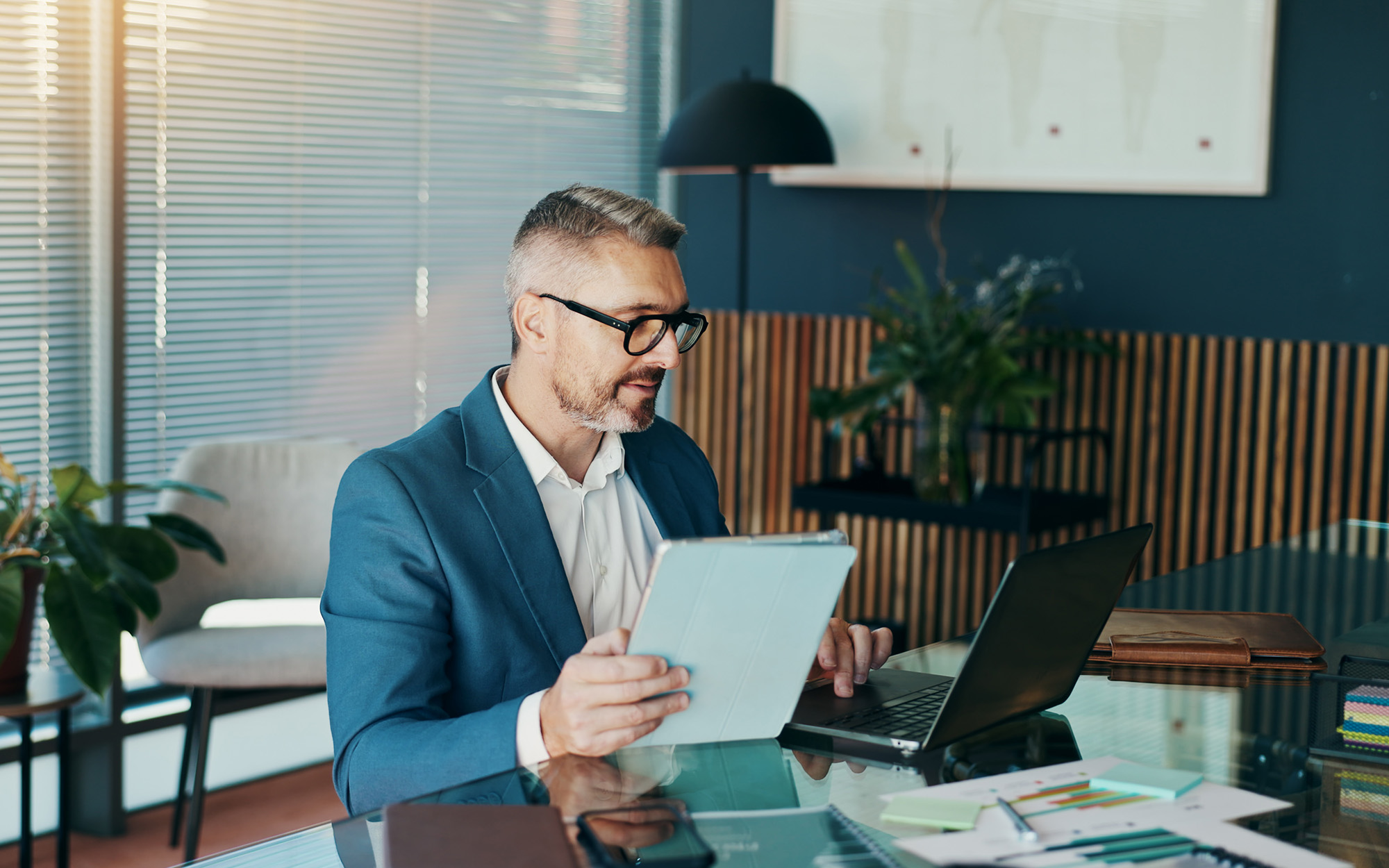 Tablet, Laptop And Reading With Business Man In Office