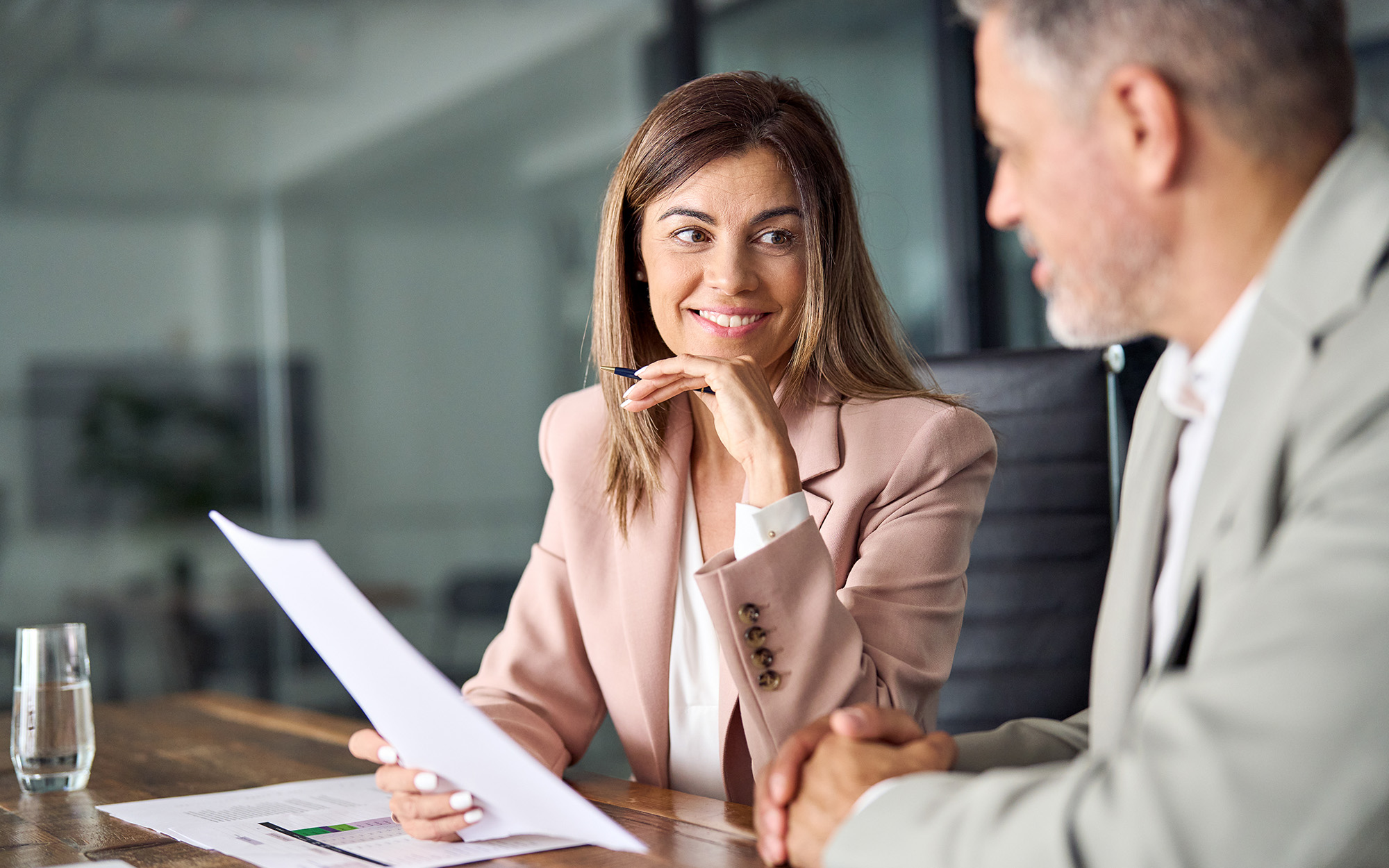 Two Business Executives Discussing Financial Legal Papers