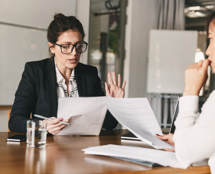 Image Of Strict Caucasian Businesswoman Holding Resume