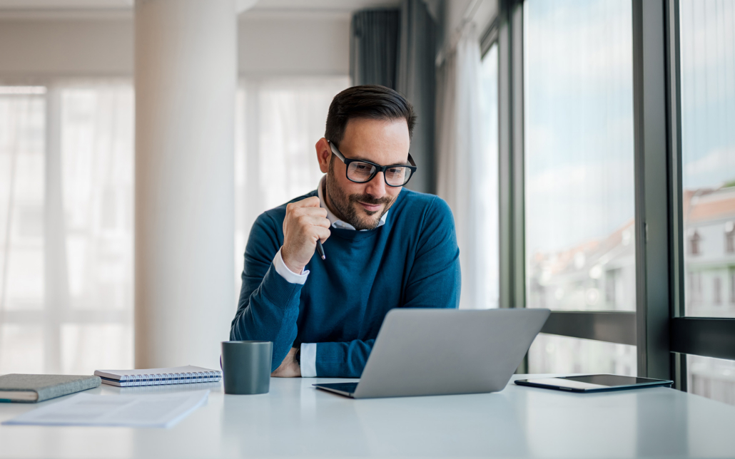 Serious Businessman Working On Laptop. Male Professional Is Planning Strategy